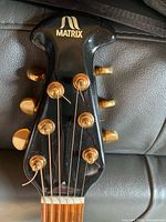Matrix guitar headstock showing brand logo and gold tuners