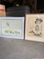 Both framed lithographs side by side