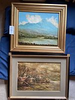 Two framed oil paintings side by side