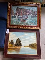 Both framed paintings stacked showing subject matter and frames