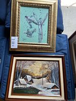 Both framed paintings laid out for overview