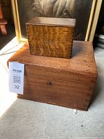 Both wooden boxes stacked closed, showing size comparison and exterior wood grain