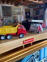 Front three-quarter view of both Tonka trucks on shelf