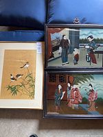 Group shot of three framed artworks