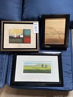 Group shot of three framed paintings