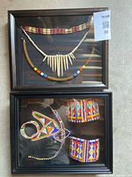 Both framed shadow boxes showing all jewellery pieces