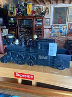 Left side view of Marx The Pioneer ride-on locomotive showing cab markings and wheels