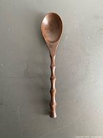Full view of carved hardwood serving spoon