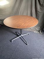 full view of assembled table showing wood-grain top and aluminum base