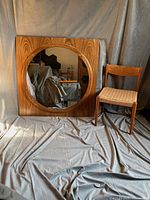 Front view showing full square frame and round mirror