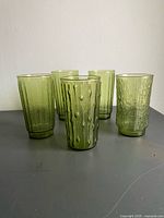 Five green textured tumblers front view showing both bark and bamboo patterns
