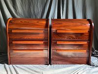 Front view of pair of rosewood roll-top nightstands