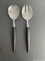 Front view of salad spoon and fork showing heads and handles
