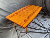 angled view showing full top, inlay patterns and tapered legs