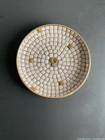 Top view showing circular ceramic mosaic pattern and gold accent tiles
