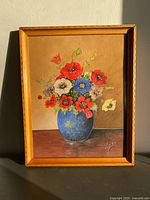Front view of framed gouache painting showing poppies in vase and artist signature