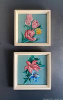 Front view of both framed floral oil paintings on glass