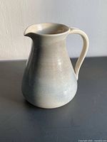 Front view showing jug shape, glaze and handle