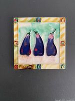 Front view of square ceramic tile with eggplant design