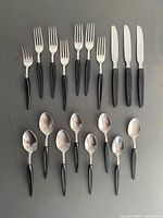 Full set laid out showing forks, knives, soup and dessert spoons