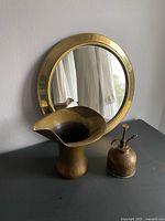 Mirror, vase and spritzer grouped to show lot contents and scale