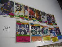 Top row of standard-size 1980 OPC hockey cards showing various teams