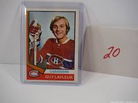 Front view of card in sleeve showing player image, team logo, name