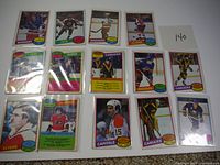 Overall view of 12 cards laid out in four rows of three on white background showing fronts and team names