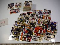 Spread of 1995 Fleer Ultra hockey cards with stack of additional cards
