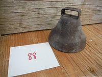 Bell side view showing handle, body and rusted patina