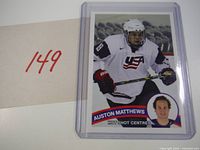 Front view of Auston Matthews Hot Shot Centres card in holder alongside lot number
