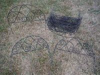 Five of the decorative steel fence panels including one stacked group, showing scroll design and overall appearance
