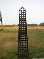 Full view of metal obelisk standing upright
