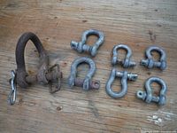 All seven shackles laid out on wood surface