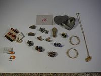 Overview of entire lot showing jewellery pieces and trinket box