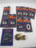 All packaged connecting links, carabiner set and hook laid out