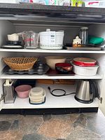 Overall view of items on three cabinet shelves