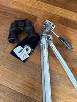 Bushnell binoculars, Image T-65 Pro tripod, small battery pack, velvet pouch