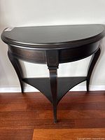 Front view of demilune table showing overall design