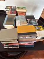Stacks of assorted books on table