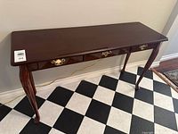 Front angled view of entire table showing drawer fronts and legs