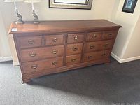 Front view of full dresser showing nine drawers and hardware