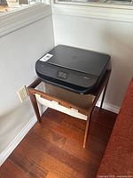 Printer on wooden stand showing overall lot
