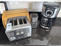 Group view of toaster, grinder, coffee maker, bread box