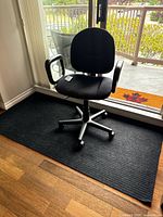 Full view of chair positioned on black floor mat