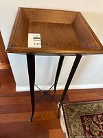 Full view of stand showing wood tray top and metal legs