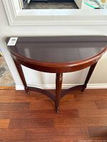 Top view of demilune table showing finish and shape