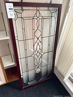 Full view of stained glass panel leaning against wall