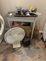 Overall lot showing side table, fan, heater, basket of tools, grapevine reindeer
