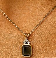 Pendant worn on chain showing scale and styling